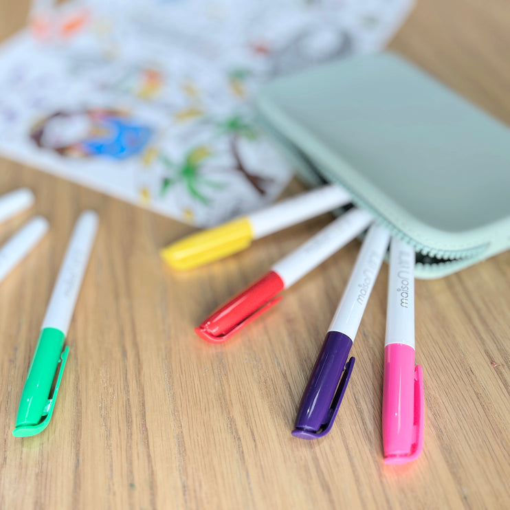Bright colored markers that come with UAE silicone placemat. All with printed brand name, Maison Tini. 