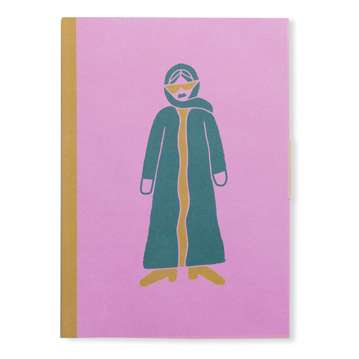 pink paper notebook with fashionista lady in black abaya.